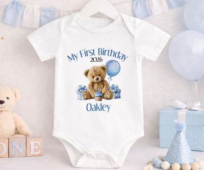 Close-up of the printed teddy bear design showing the personalised name on soft blue cotton.