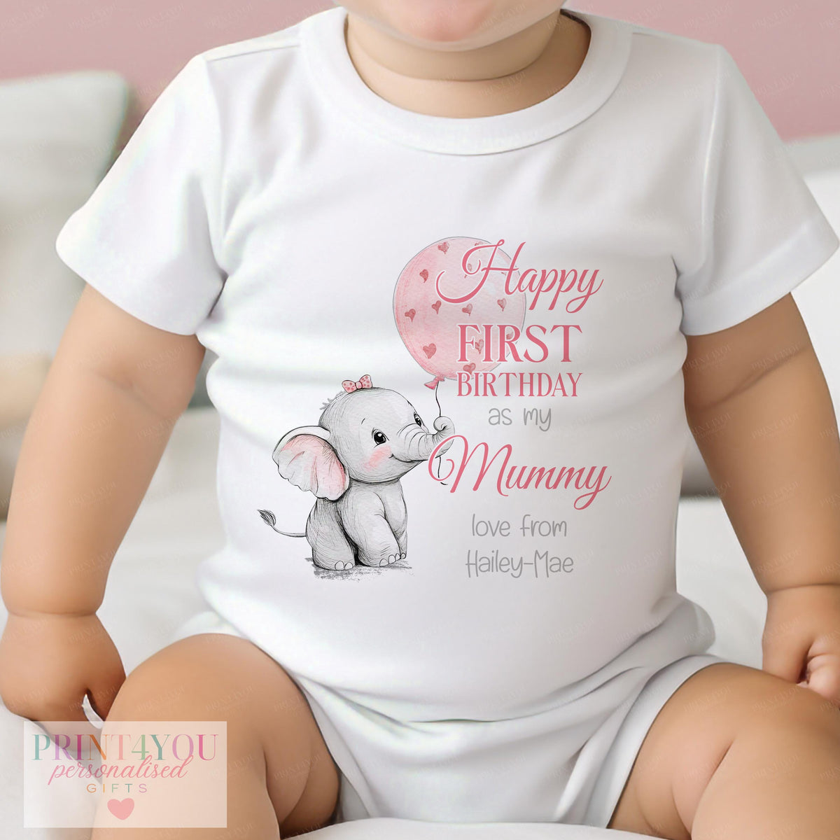 Close-up of the elephant and pink balloon print with personalised name on baby clothing
