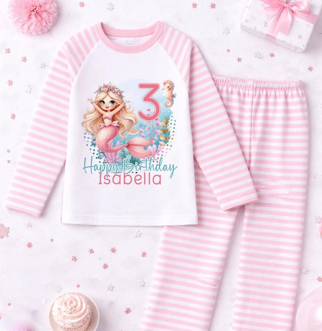 Close-up of the mermaid motif, personalised name and age printed on the pink stripe pyjama top