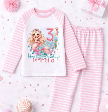 Close-up of the mermaid motif, personalised name and age printed on the pink stripe pyjama top