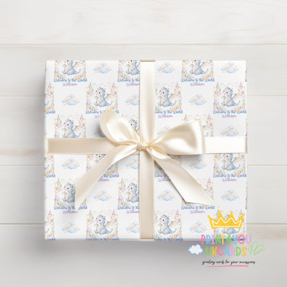 Roll of the personalised blue dragon baby wrapping paper displayed on a flat surface