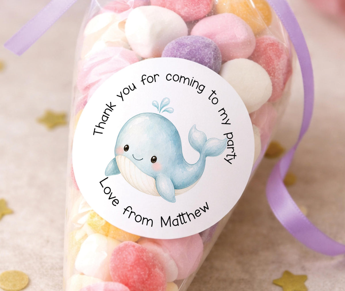 Round glossy stickers featuring a blue whale design, personalised with a child's name, for thank you party bags