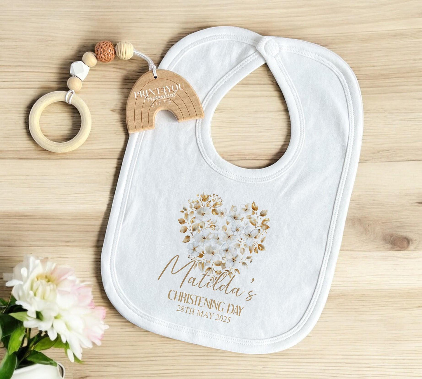 Personalised christening baby sleepsuit, close-up of floral cross print