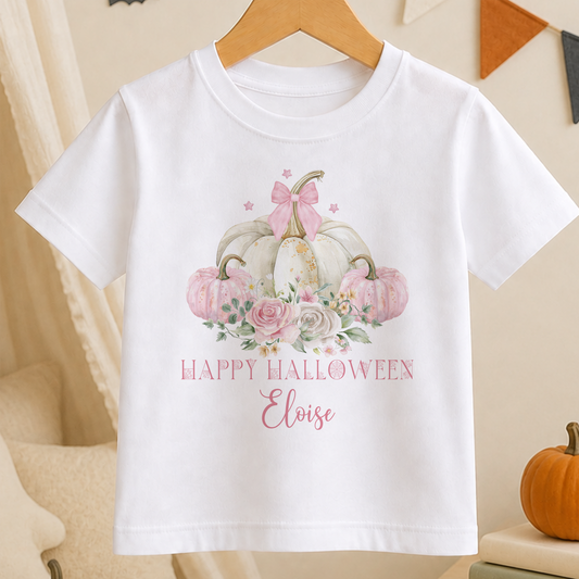 A white t-shirt with a graphic design featuring pumpkins, flowers, and the text "Happy Halloween Eloise" printed on it.