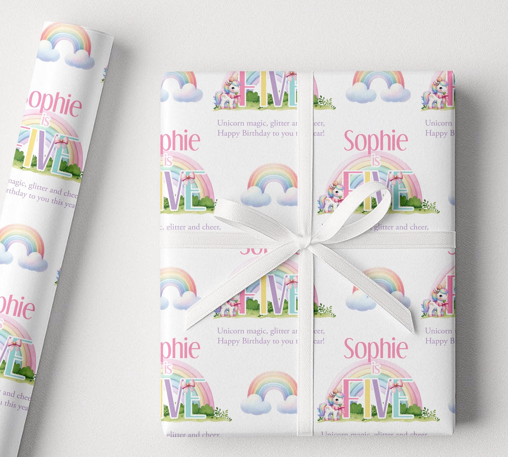 Sheet of personalised rainbow unicorn birthday wrapping paper laid flat