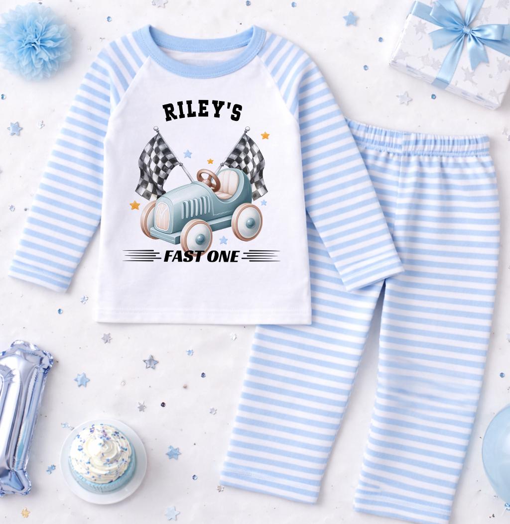 Personalised blue stripe race car pyjamas for a boy's 1st birthday with custom name