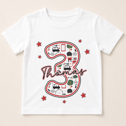 A white t-shirt with a graphic design featuring the number 3 and various icons, including a car, a train, and a building.