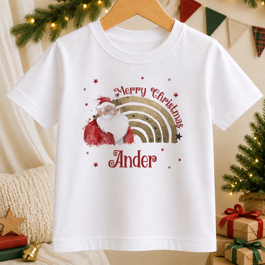A white t-shirt with a Christmas-themed design featuring a Santa Claus figure and a rainbow. The text on the t-shirt reads "Merry Christmas" and "Ander".