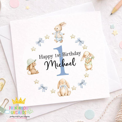 Square 1st birthday card featuring a blue bunny wreath design personalised with a baby boy's name