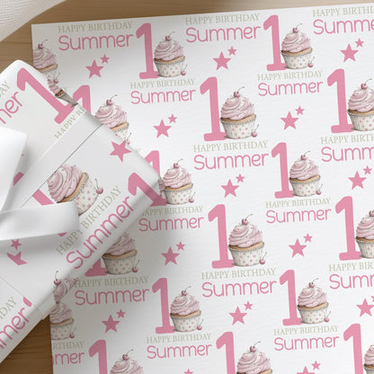Roll of personalised pink cupcake wrapping paper with an example name printed on the design