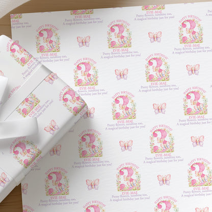 Roll of personalised pink butterfly wrapping paper with an example name and age printed on the design
