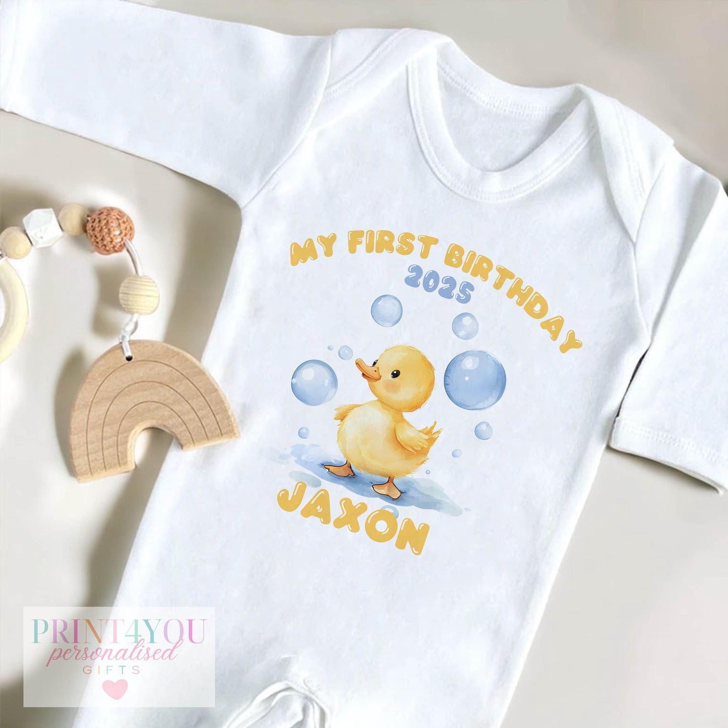 Personalised bubble duck first birthday bib with custom name printed on soft cotton