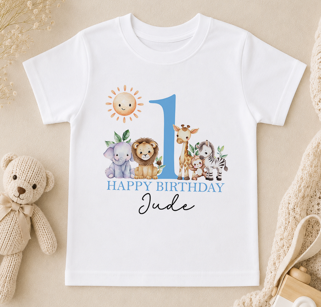 Personalised white t-shirt printed with a sun, giraffe, lion and zebra and 'Happy Birthday Jude'.