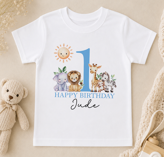 A white t-shirt with a graphic design featuring a sun, a giraffe, a lion, and a zebra, along with the text "Happy Birthday Jude" printed on it.