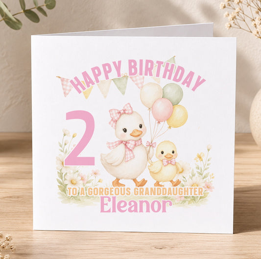 Personalised duck birthday card featuring two illustrated ducklings and pastel balloons, shown printed with the name Eleanor, age and birthday message.