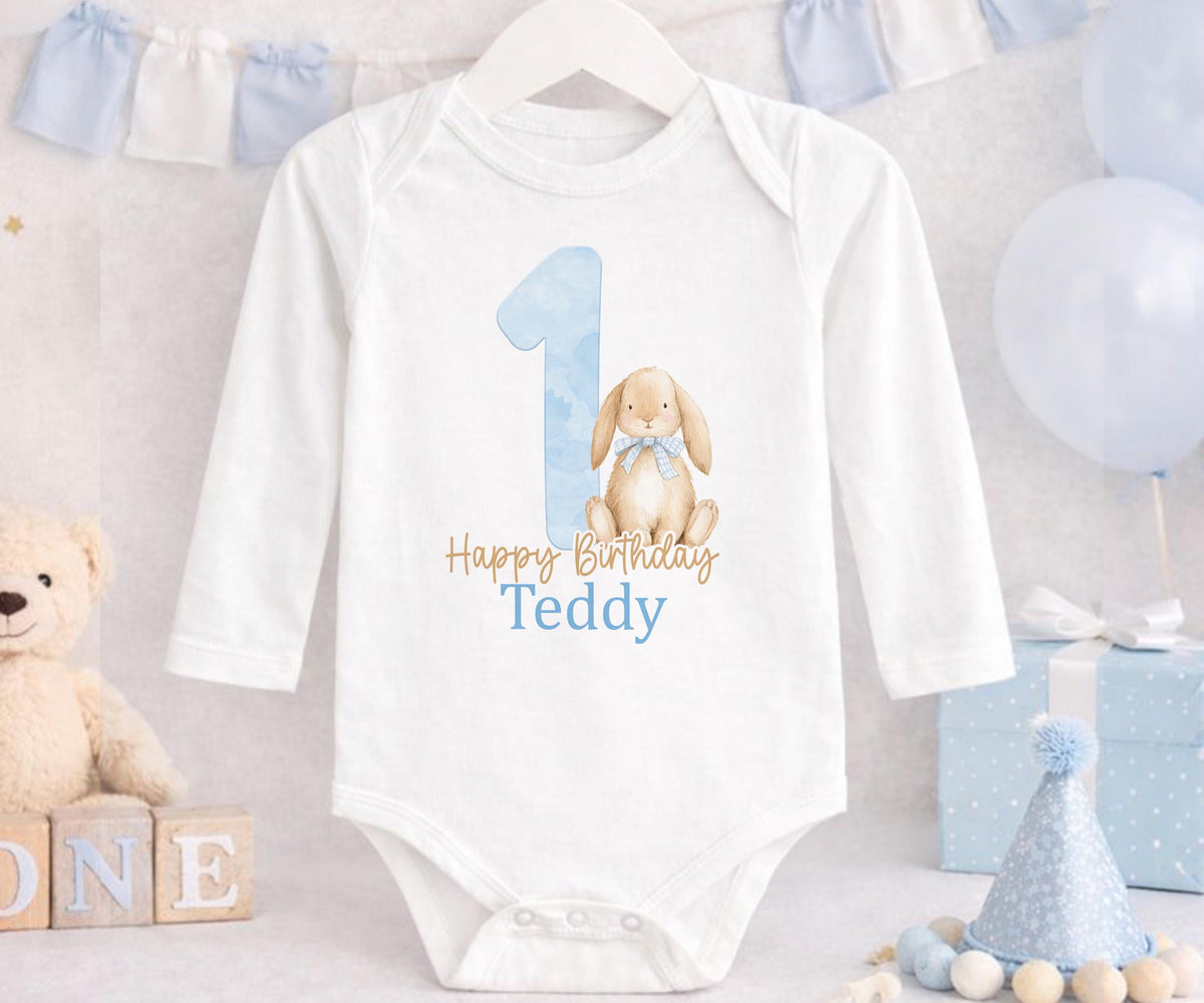 Close-up of the bunny design and custom name print on blue 1st birthday pyjamas