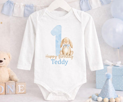 Close-up of the bunny design and custom name print on blue 1st birthday pyjamas