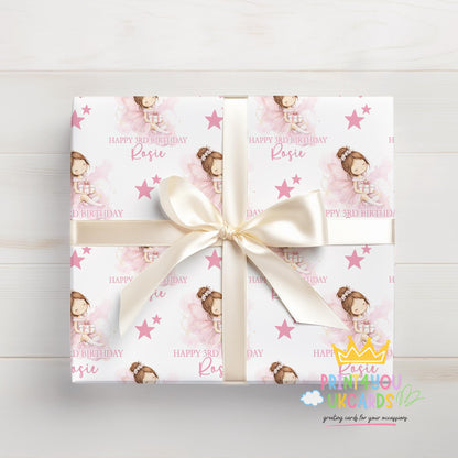 Personalised pink fairy birthday wrapping paper wrapped around a gift