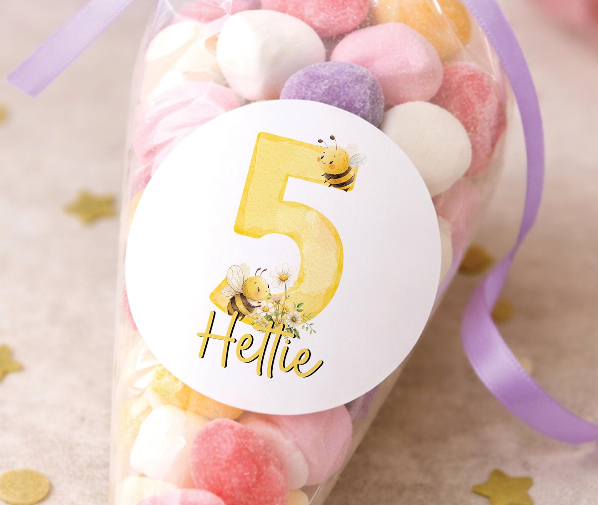 Round glossy stickers featuring a bee and floral design, personalised with a birthday child's name