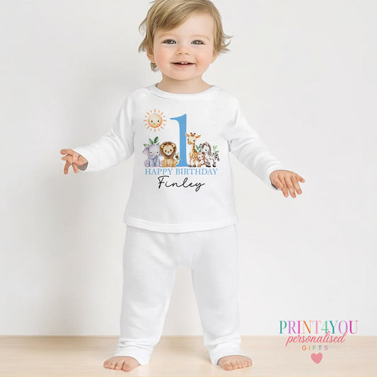 Personalised blue safari first birthday pyjamas with your child's name printed on the front, shown in 6-12 months.