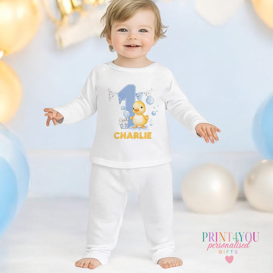 Yellow duck and bubbles personalised first birthday pyjamas for 6-12 months, printed with baby's name on soft white cotton.