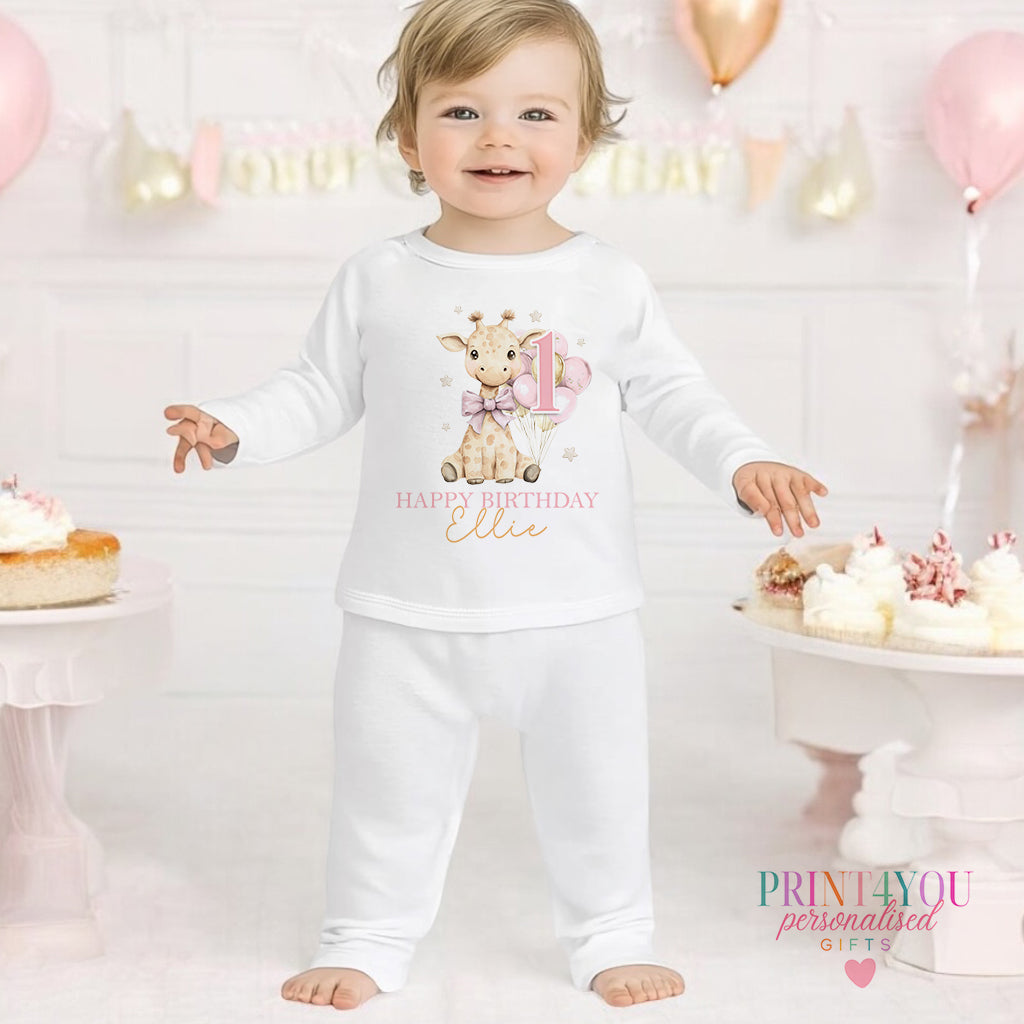 Giraffe personalised first birthday pyjamas for 6-12 months, printed with baby's name on soft white cotton.