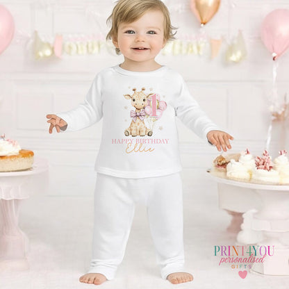 Giraffe personalised first birthday pyjamas for 6-12 months, printed with baby's name on soft white cotton.