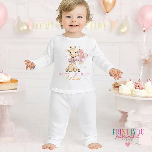 Giraffe personalised first birthday pyjamas for 6-12 months, printed with baby's name on soft white cotton.