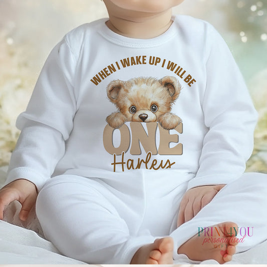 White cotton baby pyjamas with a peeking teddy bear design and personalised name, size 6-12 months.