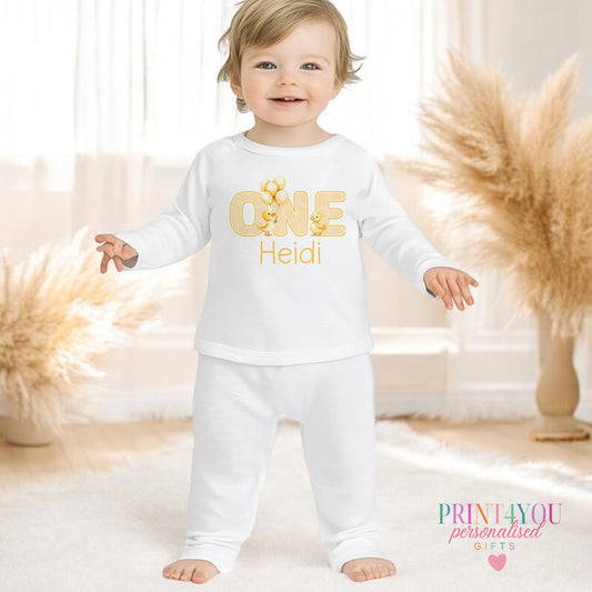 Yellow duck personalised first birthday pyjamas for 6-12 months, printed with baby's name on soft white cotton.