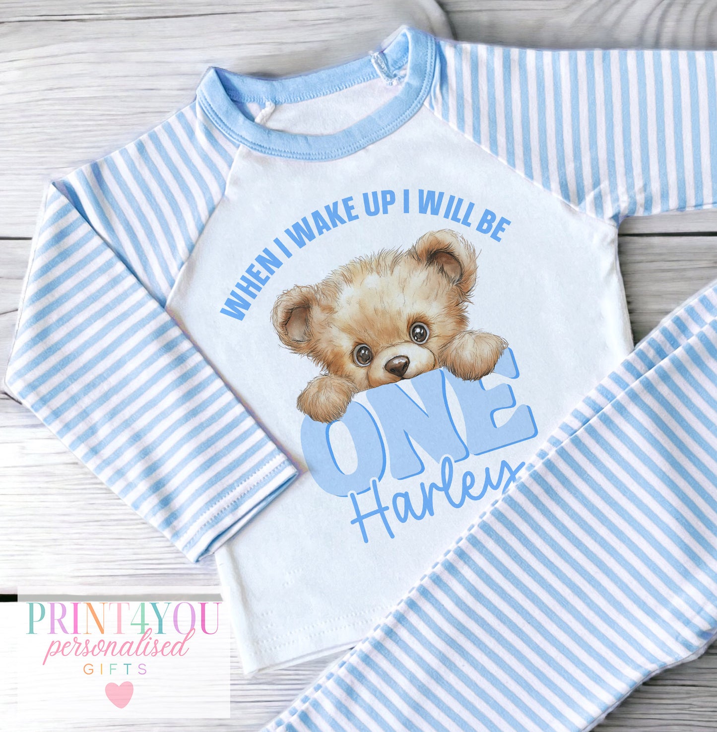 Personalised peeking teddy bear design with When I Wake Up message on blue and white striped baby and children's pyjamas, vests, sleepsuits and T-shirts, personalised with child's name
