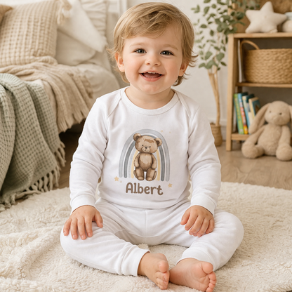 Personalised teddy bear baby vest, custom printed with the baby's name, styled in a cosy nursery setting.