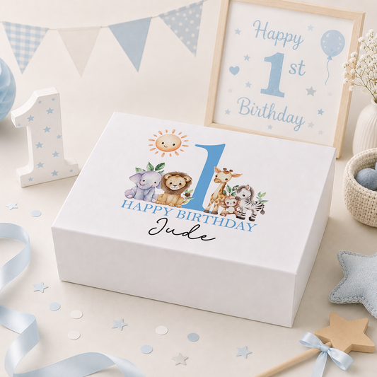 Blue personalised birthday keepsake box lid featuring a smiling sun above a lion, elephant, giraffe, monkey and zebra beside a large number, with 'Happy Birthday' and the child's name and age in playful script