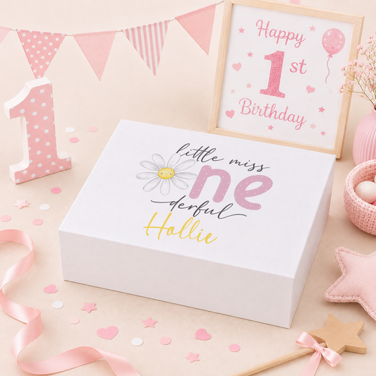 Pink and yellow 'Little Miss One-derful' 1st birthday keepsake box with a magnetic lid, featuring a smiling daisy illustration and the child's name in yellow script.
