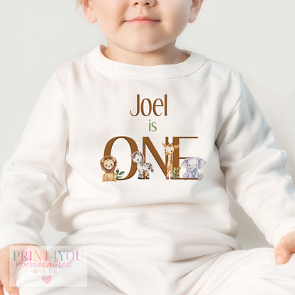 Close-up of the safari animal print, custom name and ONE design on the personalised baby pyjamas.