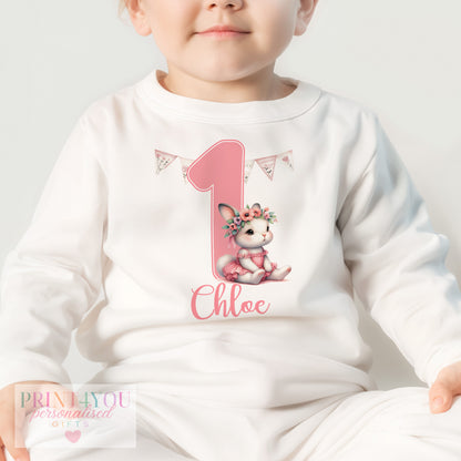 Close-up of the ballerina bunny rabbit design personalised with baby's name on pink first birthday pyjamas.