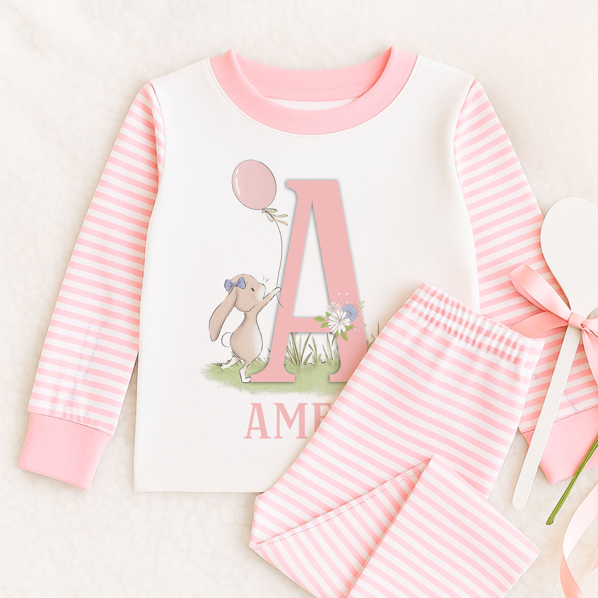 Personalised pink and white striped girls pyjamas with bunny rabbit alphabet name design