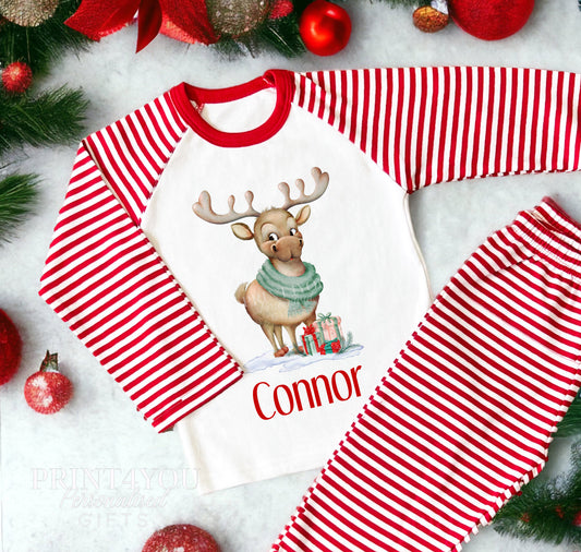 Personalised reindeer Christmas pyjamas with a child's name printed on red and white striped nightwear