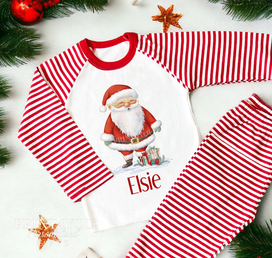 Personalised Santa Christmas pyjamas with a child's name printed on red and white striped nightwear