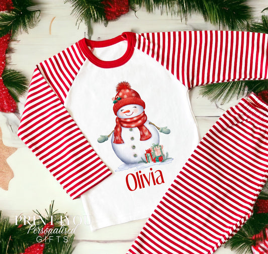 Personalised red and white striped Christmas Eve pyjamas for kids with Snowlady design and custom name printed on the front