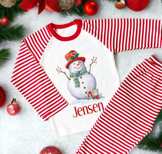 Personalised red and white striped Christmas Eve pyjamas for kids with Snowman design and custom name printed on the front