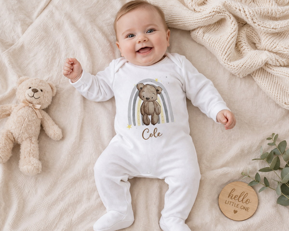 Personalised teddy bear and rainbow baby vest, printed with the baby's name.