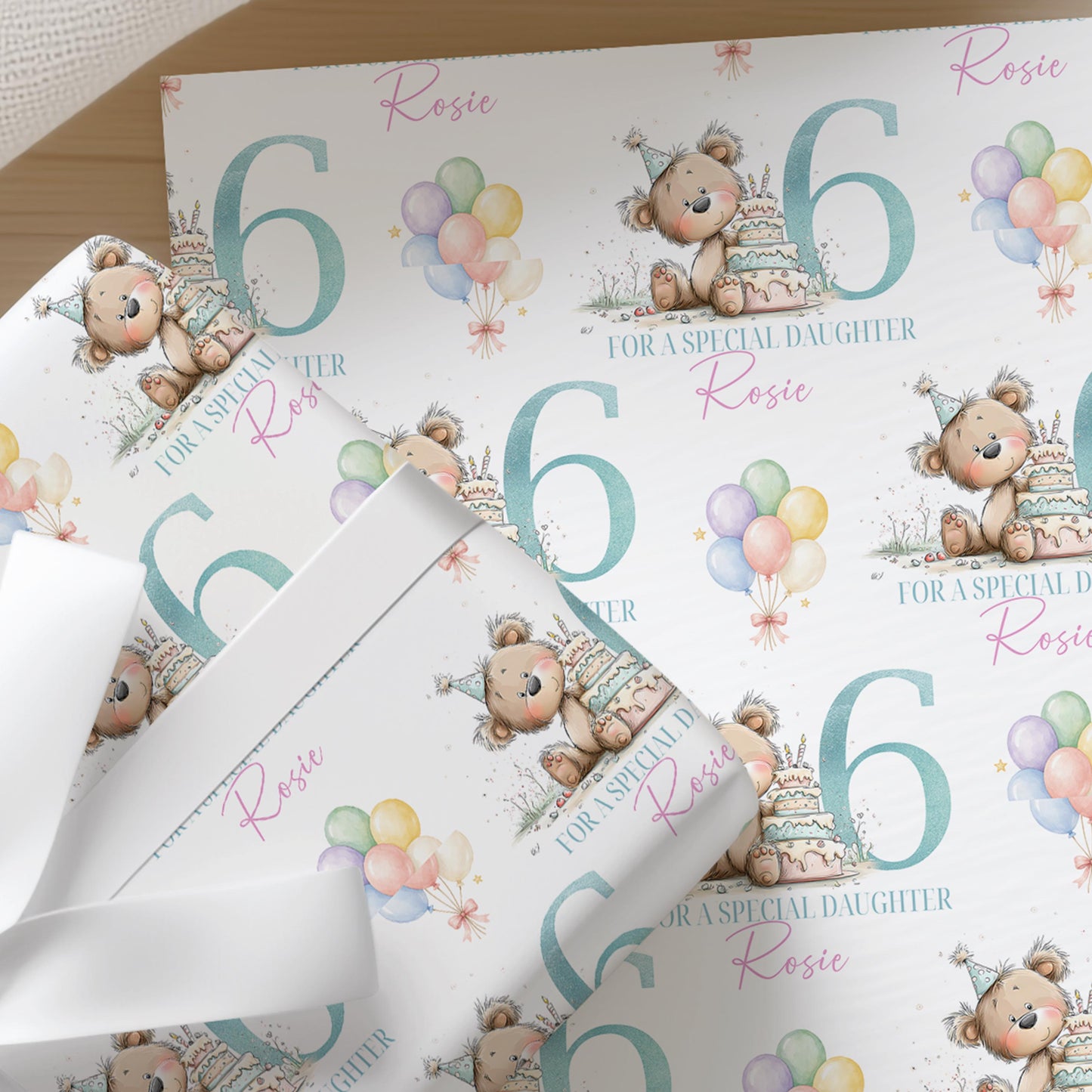 a repeating pattern of birthday-themed elements, including teddy bears, balloons, and the number 6. The text "ROSIE for a special daughter Rosie" is visible, suggesting this is a gift wrapping design for a birthday celebration.