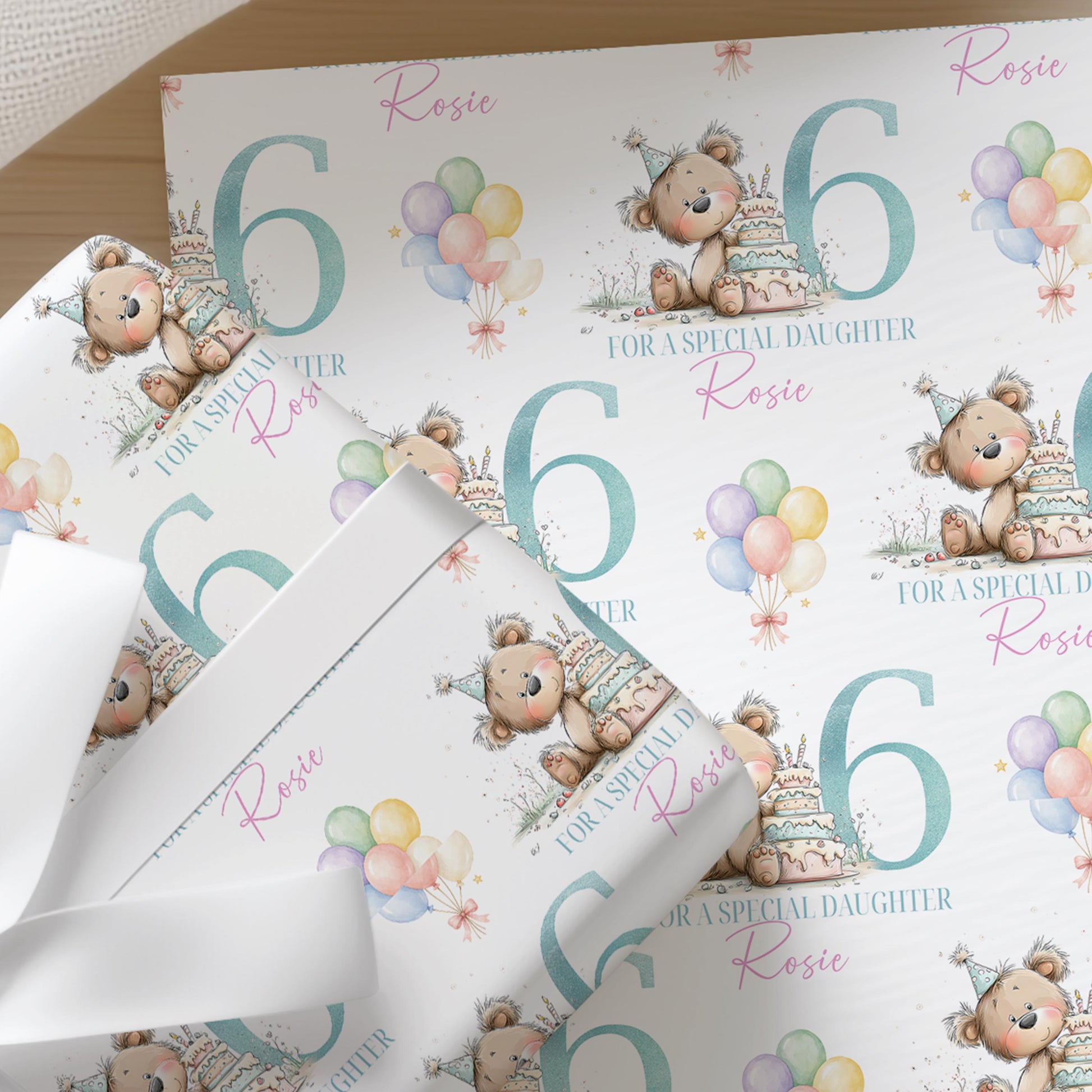 a repeating pattern of birthday-themed elements, including teddy bears, balloons, and the number 6. The text "ROSIE for a special daughter Rosie" is visible, suggesting this is a gift wrapping design for a birthday celebration.
