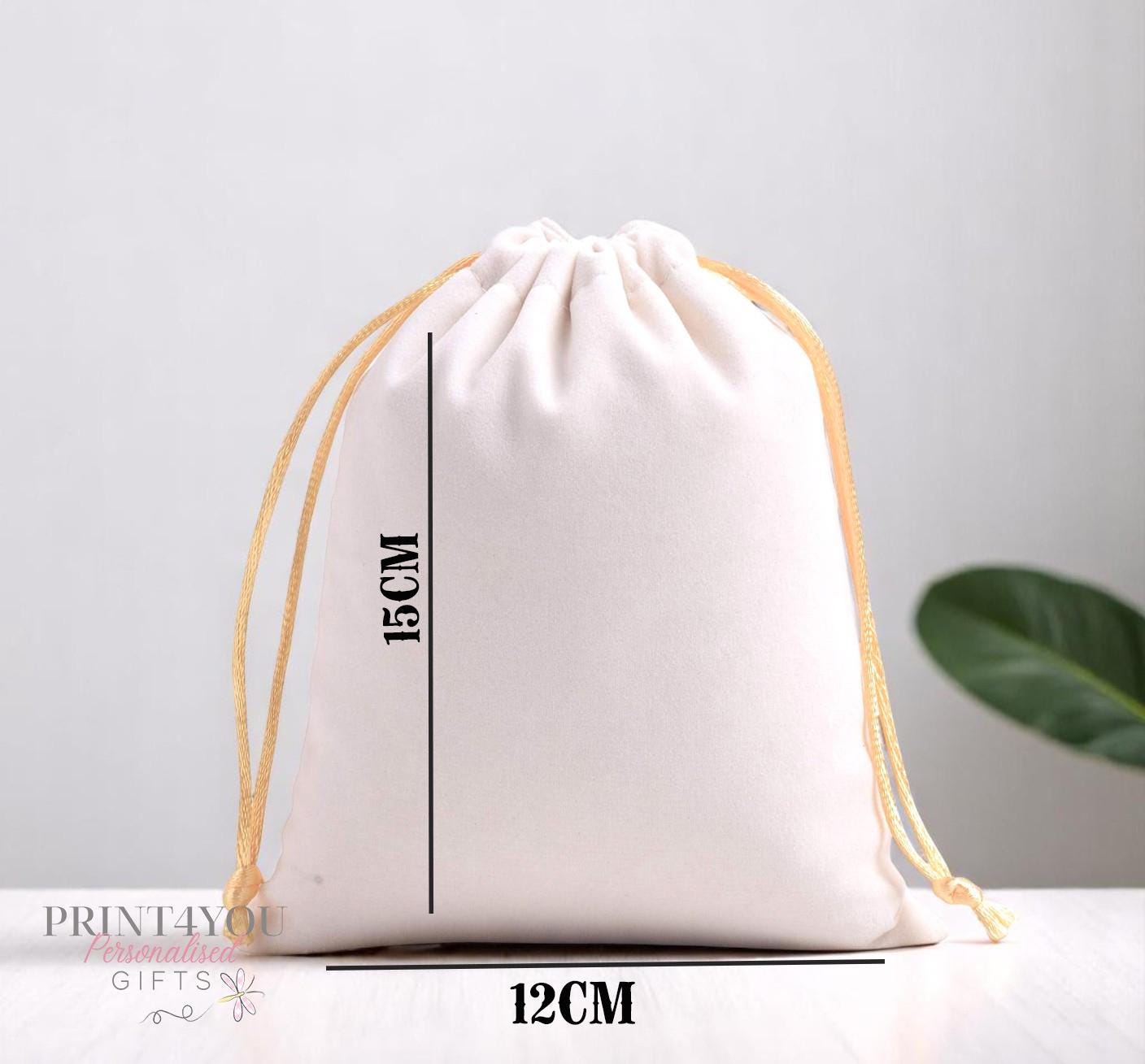 Personalised cream velvet drawstring pouch showing custom name and date print