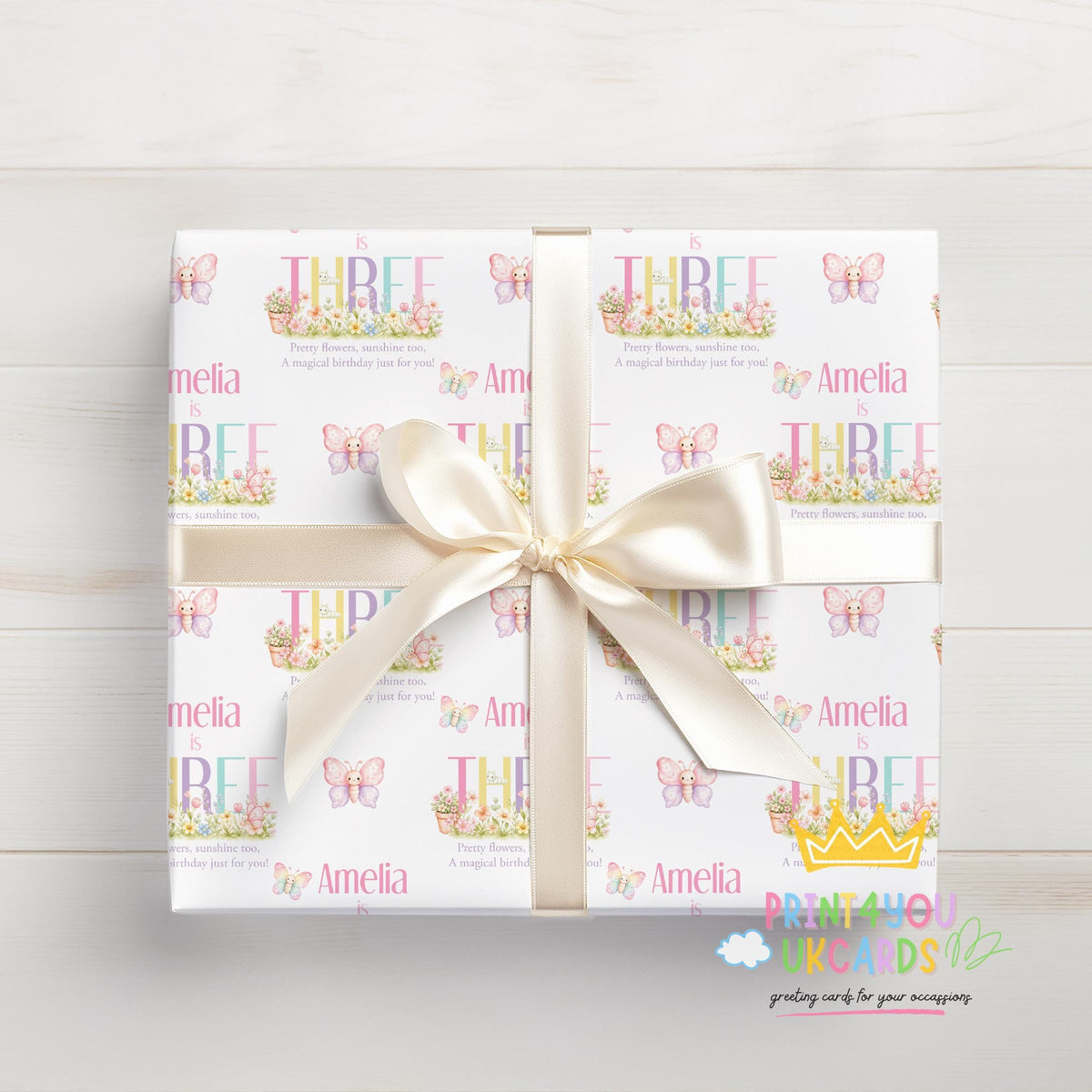 Personalised butterfly garden birthday wrapping paper wrapped around a gift