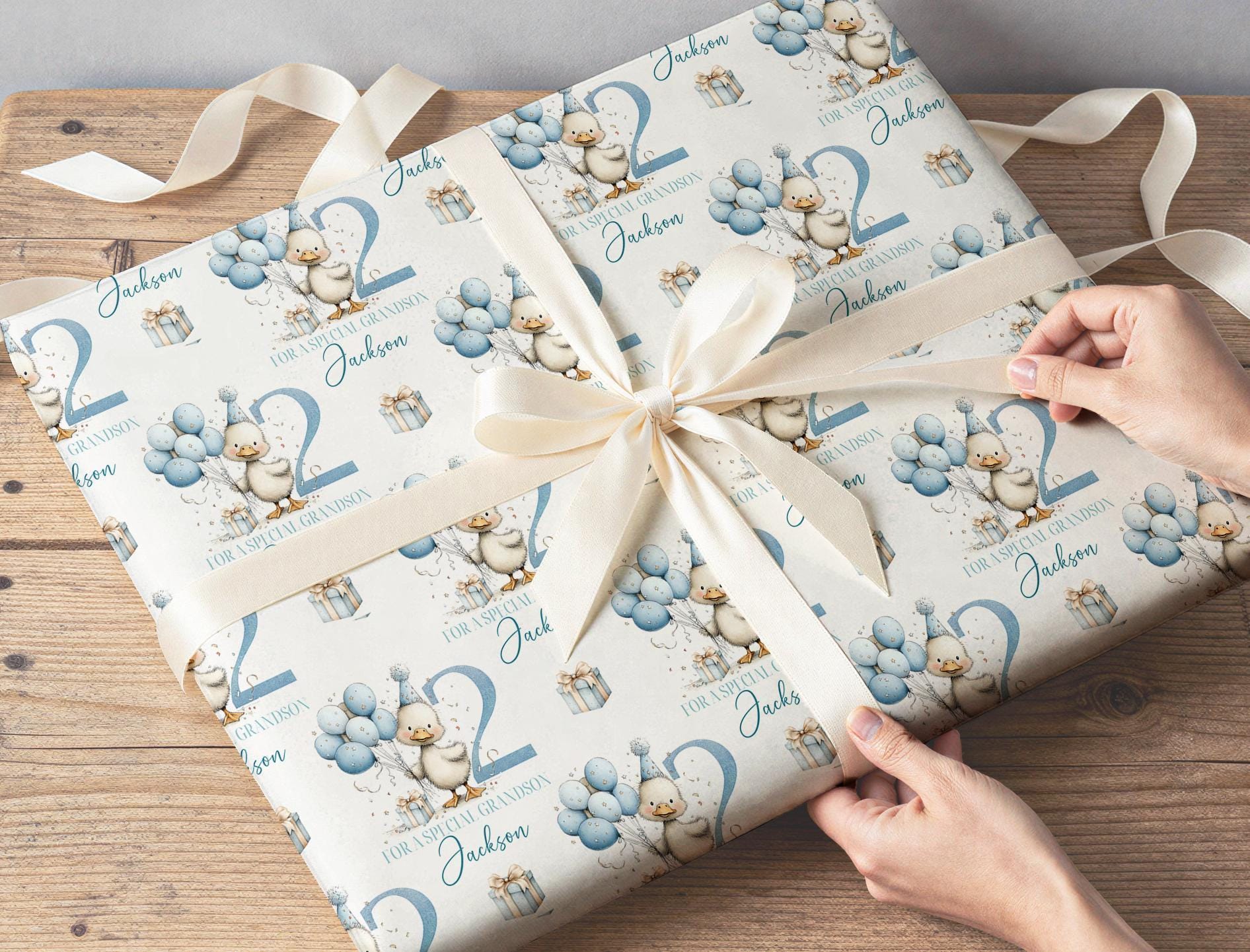 Personalised blue duck birthday wrapping paper laid flat, showing the repeating pastel duck and balloon pattern.