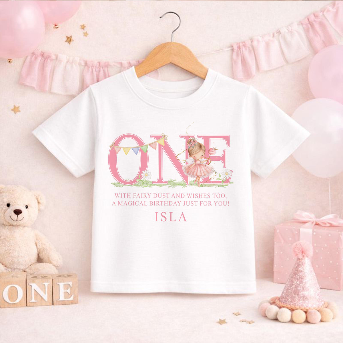 Close-up of the printed fairy design showing the personalised name on soft pink cotton.