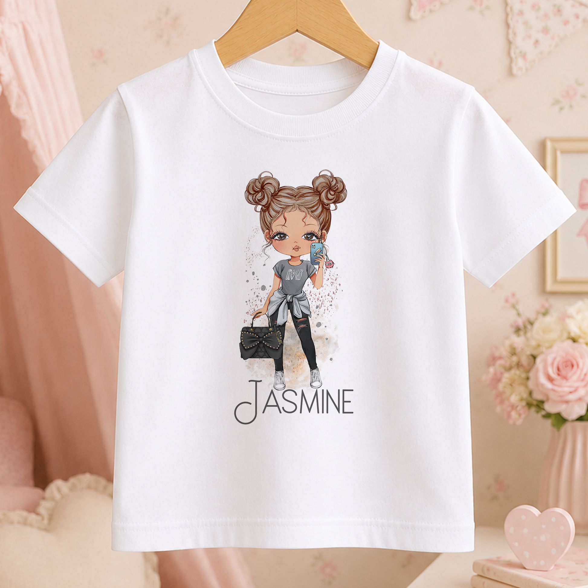 A white t-shirt with a cartoon illustration of a young girl wearing a gray outfit and holding a black purse. The text "JASMINE" is printed below the illustration.