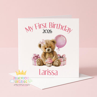 Square pink first birthday card featuring a teddy bear design, shown personalised with a name and year